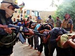 Isis militants with captured Iraqi soldiers wearing plain clothes