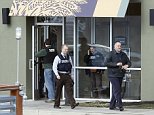 Investigators walk at the scene of a shooting at a shopping center in Abingdon, Md., Wednesday, Feb. 10, 2016. A man opened fire inside a shopping center restaurant during lunchtime. (AP Photo/Patrick Semansky)