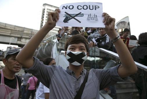 A Thai protester shows his disapproval with the military during an anti-coup protest despite the martial law in Bangkok, Thailand. The Army chief announced yesterday that the armed forces were seizing power in a non-violent coup. Thailand has seen many months of political unrest and violence which has claimed at least 28 lives. Thailand is known as a country with a very unstable political record, it is now experiencing it's 12th coup with 7 attempted pervious coups.