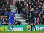 Chelsea's Spanish midfielder Cesc Fabregas (L) reacts as referee Anthony Taylor (R) shows him a yellow card for simulation after Febregas went down in the Southampton penalty area during the English Premier League football match between Southampton and Chelsea at St Mary's Stadium in Southampton, southern England, on December 28, 2014. AFP PHOTO / GLYN KIRK   RESTRICTED TO EDITORIAL USE. No use with unauthorized audio, video, data, fixture lists, club/league logos or live services. Online in-match use limited to 45 images, no video emulation. No use in betting, games or single club/league/player publications.        (Photo credit should read GLYN KIRK/AFP/Getty Images)