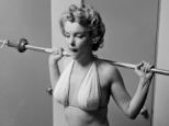 Health conscious: In an early photoshoot, Marilyn Monroe is pictured working out with weights at home