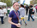 EXCLUSIVE: April 12, 2015 - St. Louis, Missouri, United States: Kendall Schler, 26, is seen moments after crossing the finish line of the Go! Marathon. Behind Schler is Jackie Joyner Kersee. Schler said that she wasn't sure if she was the first woman runner to cross the finish line. Kendall Schler was the first woman to cross the finish line at the 2015 GO! St. Louis Marathon and received the glory other hoped to enjoy. She was photographed with Jackie Joyner-Kersee on and stood to collect the $1,500 first prize. She also had improved her time from her third-place finish in 2014, a mark that was good enough to qualify for the Boston Marathon. Race officials had determined Schler did not run the marathon in downtown St. Louis either year. She is believed to have slipped onto the course after the last checkpoint in an attempt to fool race officials into believing she ran the entire 26.2 miles. Officials said that Schler did not register any times on the route, and that a review of last