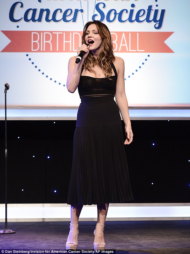 Singing for charity: The 31-year-old actress' black halter dress and nude peep-toe platforms were likely selected by her stylist Jeff K. Kim