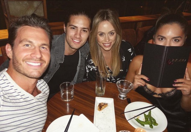 Double date: The pair appeared to be on a a double date with the starlet's Neighbours co-star Travis Burns and his fiancée Emma Victoria Lane (centre)