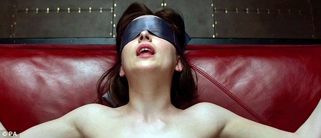 Dakota Johnson as Anastasia Steele tied to the bed in the film. EL James says the lingerie reflects the story