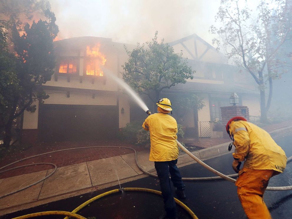 PHOTO: Los Angeles firefighters battle to contain flames to a burning home and prevent the fires spread to adjoining properties in the Bel Air district of Los Angeles on Dec. 6, 2017.