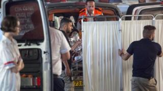 Medics evacuate an Israeli woman who was injured in the attack