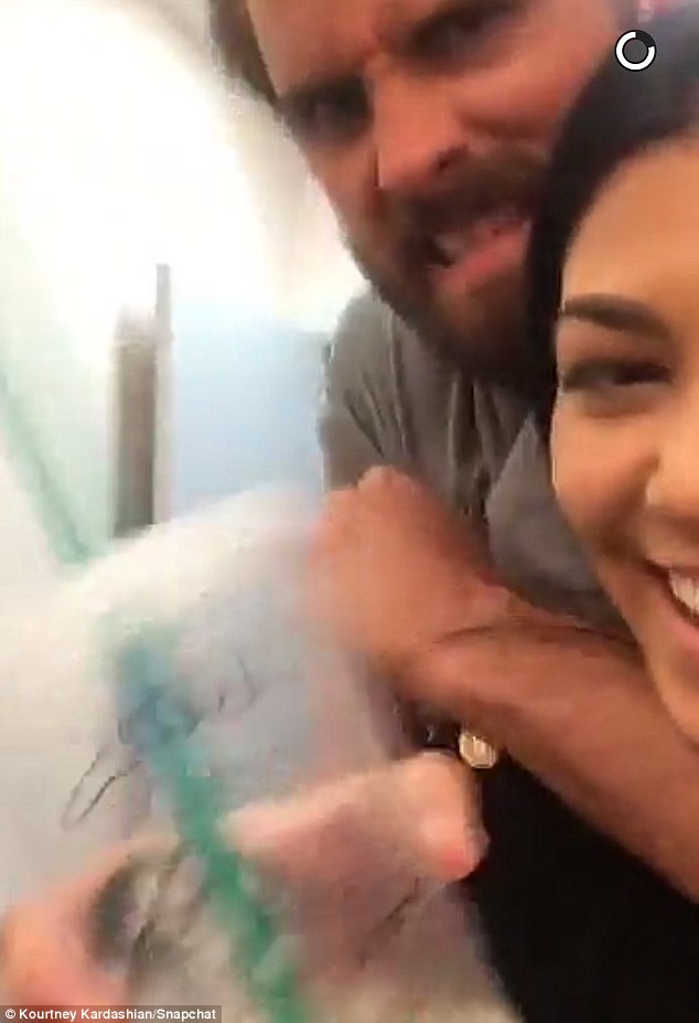 Having fun: Scott playfully grabs Kourtney after joking she was 'playing hard to get'