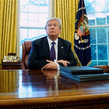 Image: Trump signs directives to impose tariffs on washing machines and solar panels in the Oval Office at the White House in Washington