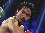 Manny Pacquiao, left, of the Philippines, trades blows with Timothy Bradley, in their WBO welterweight title boxing fight Saturday, April 12, 2014, in Las Vegas. Pacquiao won the bout by unanimous decision. (AP Photo/Isaac Brekken)