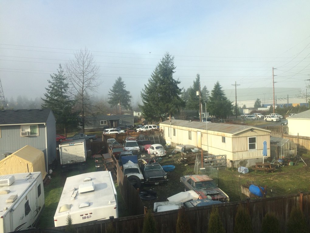 Deputy Daniel McCartney was shot to death after responding to a reported home invasion at the gray house, seen at center in the distance. (Sara Jean Green / The Seattle Times)