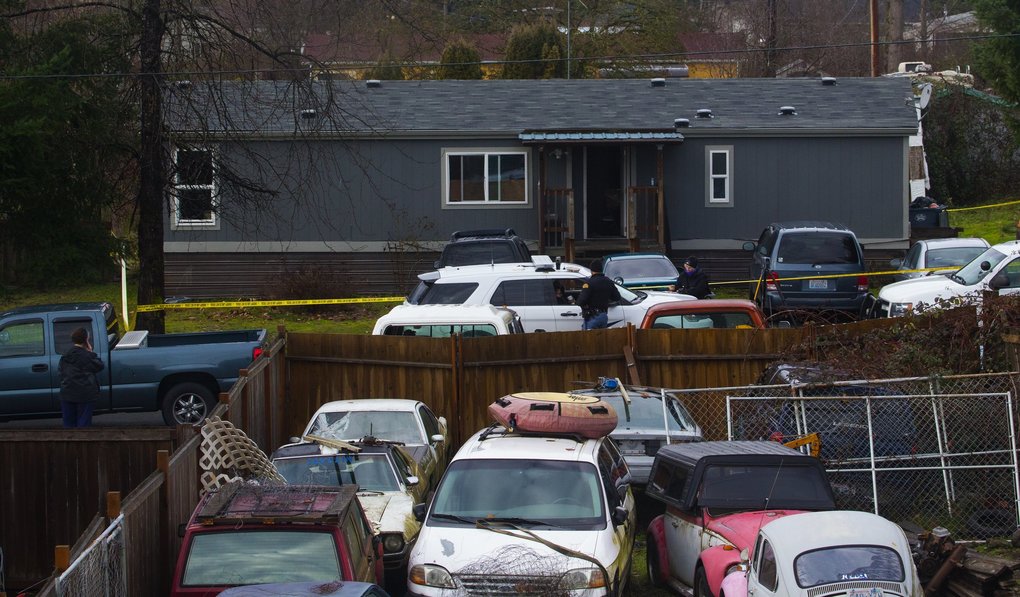 Deputy Daniel McCartney was responding to a reported home invasion at this gray house, viewed from a neighboring home.  (Ellen M. Banner / The Seattle Times)