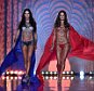 Brazilian models Adriana Lima (L) and Alessandra Ambrosio walk the runway wearing the 2 million US (1.2 million British pounds,1.6 million euros) Fantasy bras during the 2014 Victoria's Secret Fashion Show at Earl's Court exhibition centre in London on December 2, 2014. AFP PHOTO / LEON NEAL == RESTRICTED TO EDITORIAL USE ==LEON NEAL/AFP/Getty Images