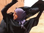 A woman removes a Niqab she was wearing in her village after Syria Democratic Forces (SDF) took control of it, on the outskirts of Manbij city, Aleppo province, Syria June 9, 2016. REUTERS/Rodi Said      TPX IMAGES OF THE DAY