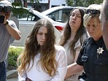 Trial set: Mary C. Rader, in white, and her mother, Deana Beighly, center, are lead by sheriff's deputies from the courthouse to an awaiting police vehicle on Thursday