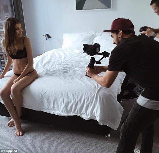 Professional poser: The model is seen posing in her underwear as she sat upright on a plush bed 