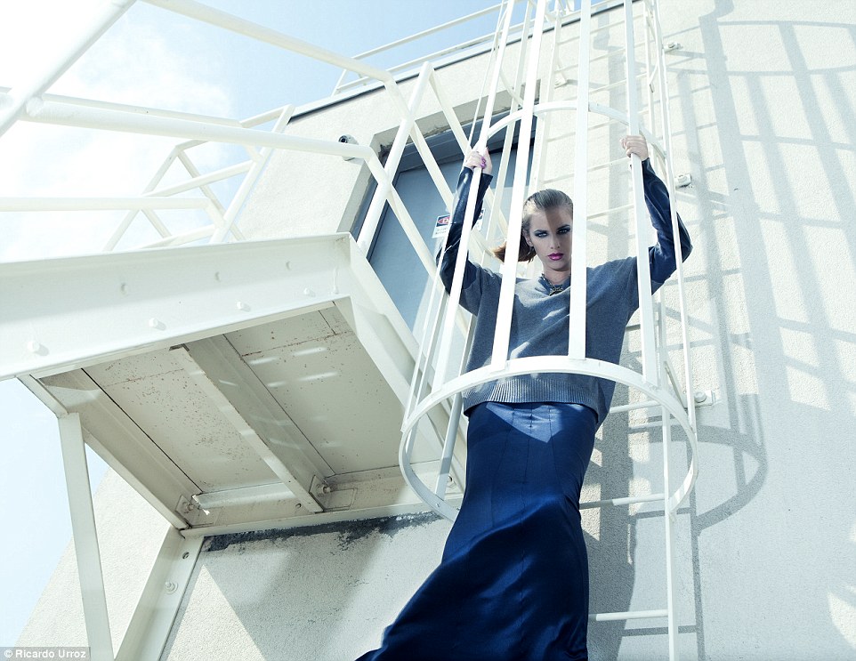 Escape: Miss Pyka climbs a fire escape in a navy dress. The pictures were shot for a fashion feature entitled: Woman On Top