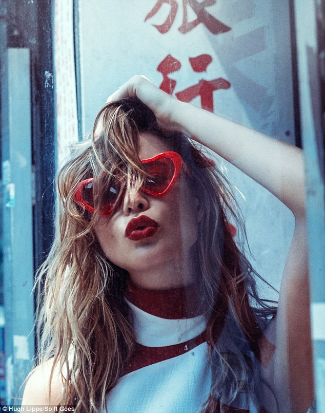 Red hot: In this fun image Behati dons heart-shaped glasses and pouts with bright red lips