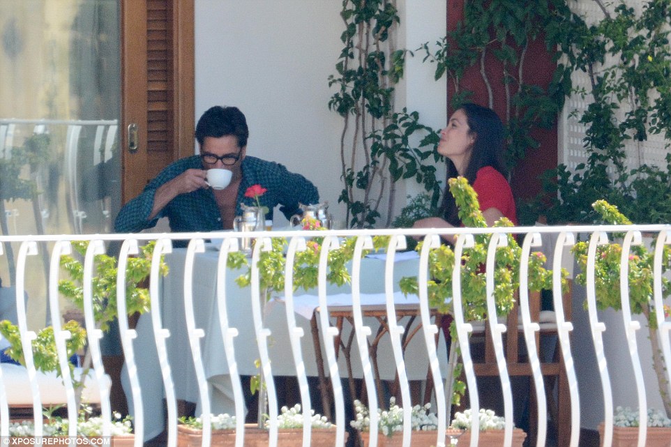 Civilised: The loved-up couple later toned down their affections to enjoy a light lunch out on the lanai 