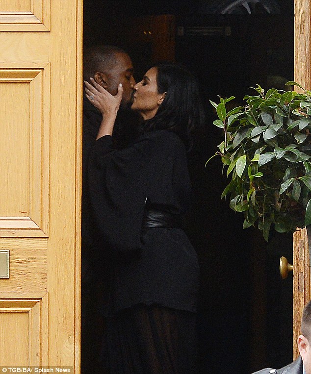 Proud: Kim delivered her husband a passionate kiss on the doorstep of Abbey Road Studios in London on Thursday morning