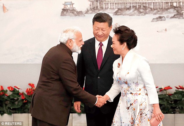 Chinese President Xi Jinping and his wife Peng Liyuan greet Indian Prime Minister Narendra Modi before the welcoming banquet for the BRICS Summit, in Xiamen, China