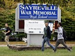 Students leave Sayreville War Memorial High School at the end of the day, Tuesday, Oct. 7, 2014 in Sayreville, N.J. Sayreville a town that found encouragement in its winning high school football team after the devastation of Superstorm Sandy was left to absorb another blow Tuesday after school officials canceled the season over allegations of bullying, intimidation and harassment among players. (AP Photo/The Star-Ledger,Patti Sapone)  TV OUT; MAGS OUT; INTERNET OUT; NO SALES; NO ARCHIVING