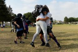 HIT LIKE A GIRLmdash;Ventura County Wolfpack football player Sonia Deputee, right, wraps up teammate Kimberly Lawson during practice. Photos by MICHAEL COONS/Acorn Newspapers 