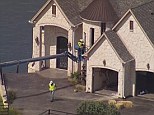 Smash: Construction workers soon moved the crane up to the home's windows