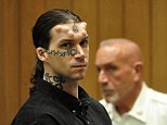 Back in court: Defendant Caius Veiovis, left, is handcuffed as he is led out of the courtroom during a recess in his triple murder trial at Hampden County Superior Court Tuesday