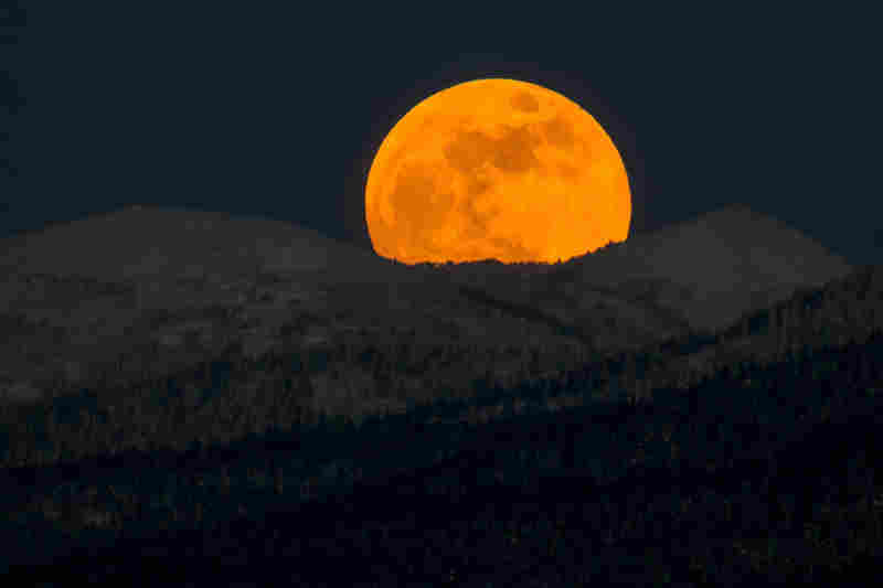 A red supermoon rises over hills near the city of Yuzhno-Sakhalinsk on Sakhalin Island in Russia's Far East. 