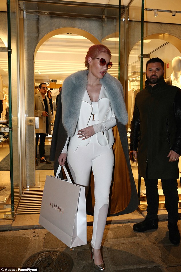 One shopping trip, two outfits: Iggy left the boutique dressed in an all-white ensemble with a black and a overcoat 