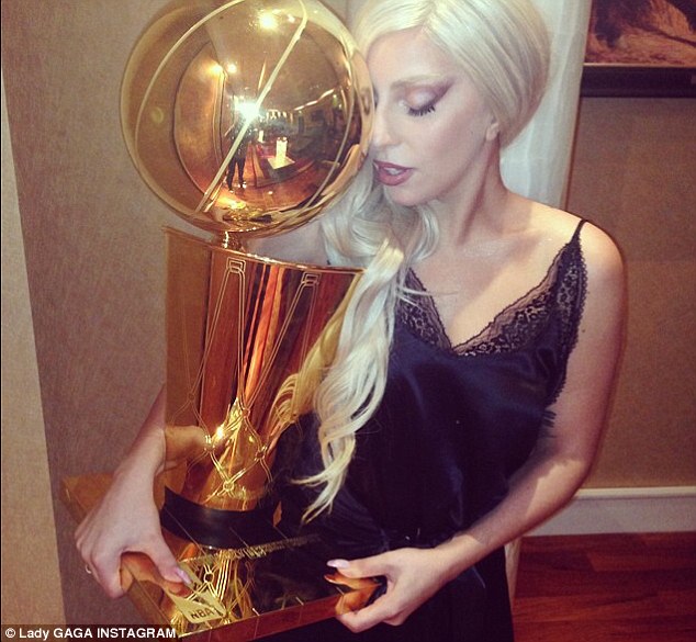 Special treatment: She was thrilled when she got to hold the trophy, Instagramming a shot of herself and the impressive accolade, with the caption: 'The Spurs and NBA were so sweet to me last night! They even let me hold their championship trophy! I felt like such a lady!'