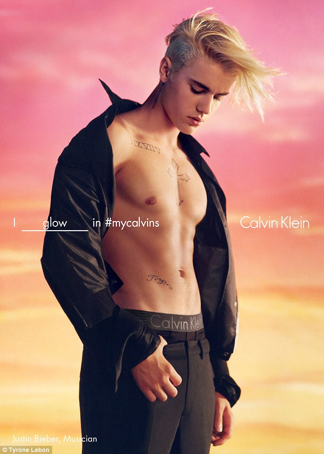 Abs-tastic: Justin Bieber teased at his Calvins waistband as he posed with his shirt open