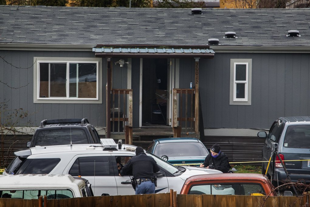 Deputy Daniel McCartney was responding to a reported home invasion at this gray house, viewed from a neighboring home.  (Ellen M. Banner / The Seattle Times)