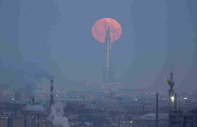 The moon is seen behind the business tower Lakhta Centre, which is under construction in St. Petersburg, Russia.