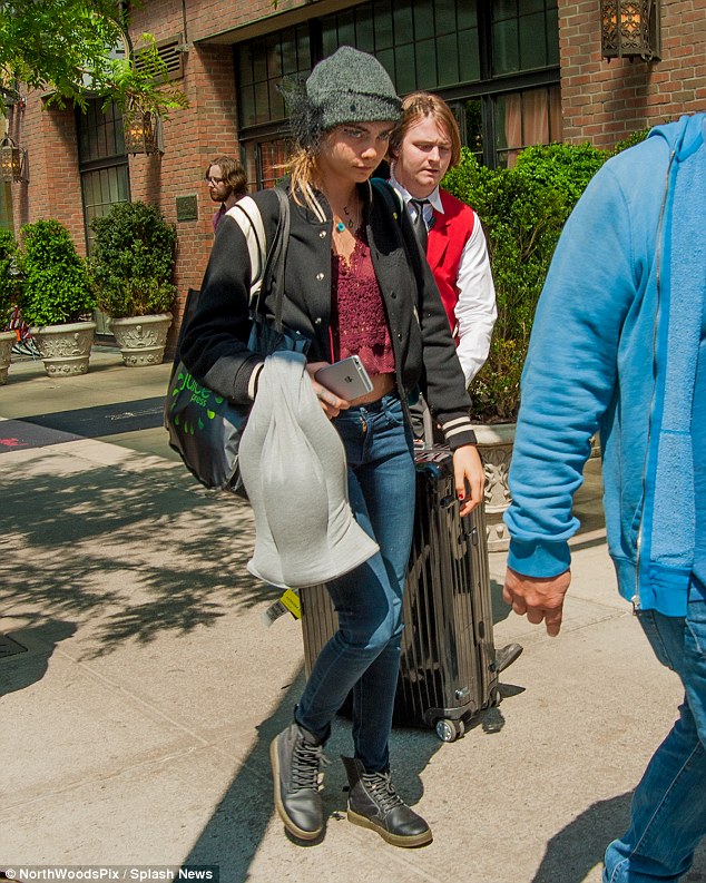 Incognito: Cara Delevingne looked less glamorous as she left her NYC hotel on Friday