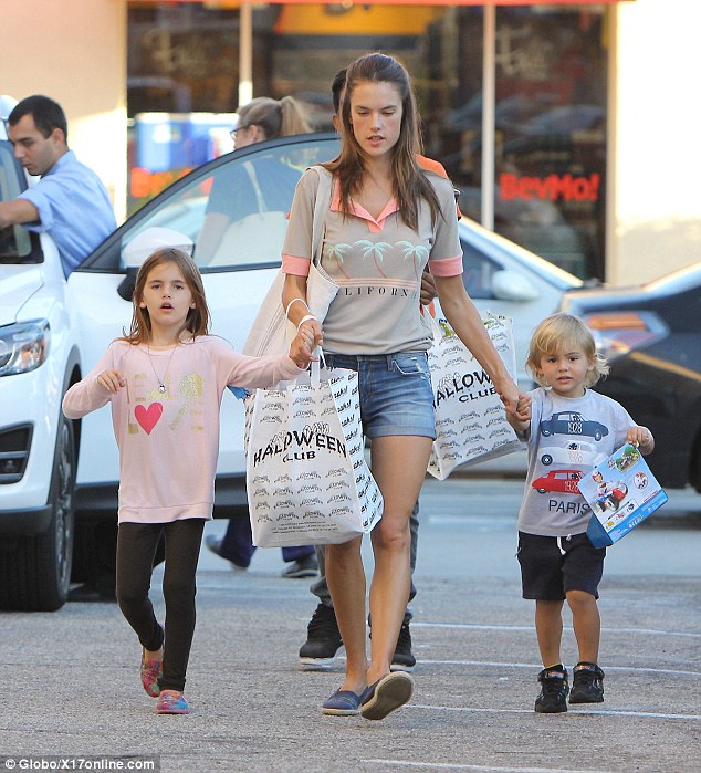 Keeping close! Alessandra kept a firm grip on her two children Anja, seven, and Noah, three, as they left the store