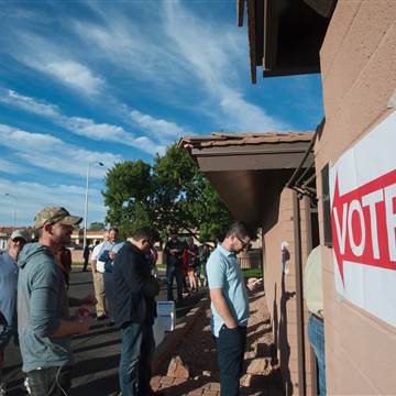 Image: Voters wait in line in front of a polling station  in Scottsdale, Arizona