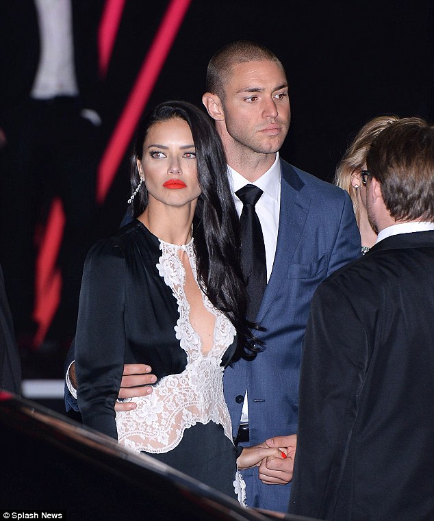 Holding on: Adriana was joined by her dashing boyfriend Joe who supported her as she departed the party