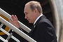 This handout photo taken and released by G20 Australia on November 16, 2014 shows Russia?s President Vladimir Putin (C) waving goodbye as he leaves the G20 Summit, at the airport in Brisbane. Putin jetted out of Australia after a testy G20 summit where he faced concerted Western fire over the Ukraine crisis, saying he left slightly early because he needed to get some sleep.      AFP PHOTO / Steve Holland/ G20 Australia ----EDITORS NOTE ---- RESTRICTED TO EDITORIAL USE - MANDATORY CREDIT 