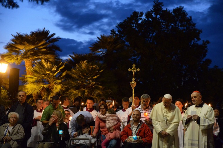 Pope Francis, center, prays at the Lourdes Grotto in the Vatican's Gardens during the celebration of a rosary event marking the closing of the Marian month on May 31, 2014. (Vincenzo Pinto/AFP/Getty Images)