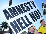 LAS VEGAS, NV - NOVEMBER 21: Demonstrators protest President Barack Obama's deferred deportation  for 5 million undocumented immigrants in the United States, allowing them to seek work permits and travel to other countries outside Del Sol High School on November 21, 2014 in Las Vegas, Nevada.PHOTOGRAPH BY UPI /Landov / Barcroft MediaUK Office, London.T +44 845 370 2233W www.barcroftmedia.comUSA Office, New York City.T +1 212 796 2458W www.barcroftusa.comIndian Office, Delhi.T +91 11 4053 2429W www.barcroftindia.com