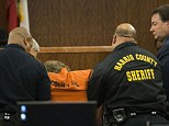 Courtroom collapse: Ron Haskell, 33, seen in orange jail garb in the center, passed out during his first court appearance in Houston Friday