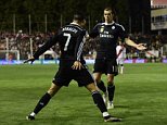 Real Madrid's Portuguese forward Cristiano Ronaldo (L) celebrates a goal with teammate Real Madrid's Welsh forward Gareth Bale during the Spanish league football match Rayo Vallecano de Madrid vs Real Madrid CF at the Estadio de Vallecas in Vallecas a suburb of Madrid on April 8, 2015.   AFP PHOTO / JAVIER SORIANOJAVIER SORIANO/AFP/Getty Images