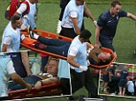 Carried off: Lewin is taken off on a stretcher with a dislocated ankle amid England's goal celebrations