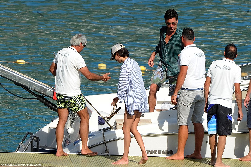 Setting sail: The passionate pair are helped on and off the private boat by a team of local mariners  