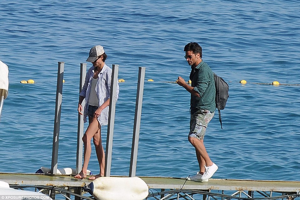 Soaking up the sun: John and Caitlin clearly aren't struggling to have a good time as they bask in the warm weather 