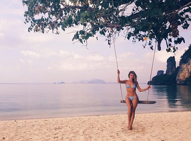 The land of smiles: She perched on a swing in one of her holiday snaps, calling the destination a 'Land of smiles'