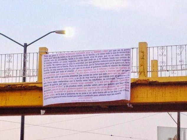 This is the sign El Chive hung from a busy pedstrian bridge in Tampico in which the crime boss accused 'Senor Thor' of taking eight million pesos during a drug raid