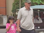 Arrest: Suspected paedophile Michael Jones was arrested by Cambodian police after he was snapped strolling hand in hand with an 11-year-old girl in Phnom Pen